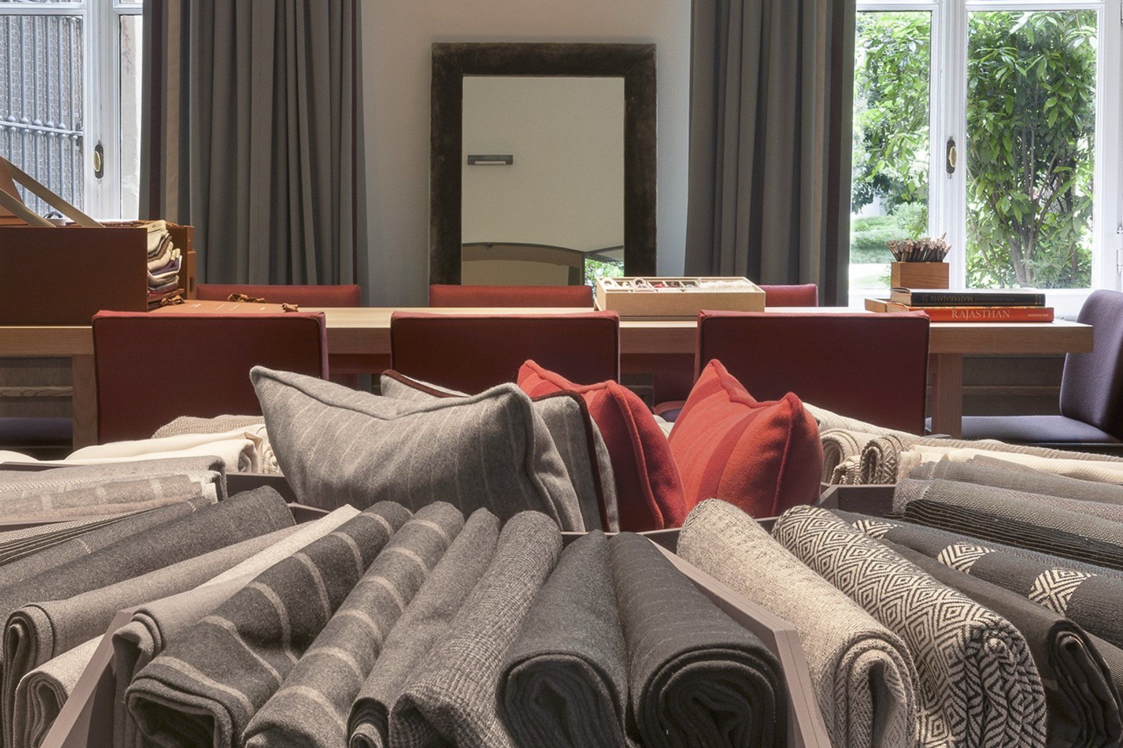 Rolls of Loro Piana Interiors furnishing fabrics in the i Vigna showroom